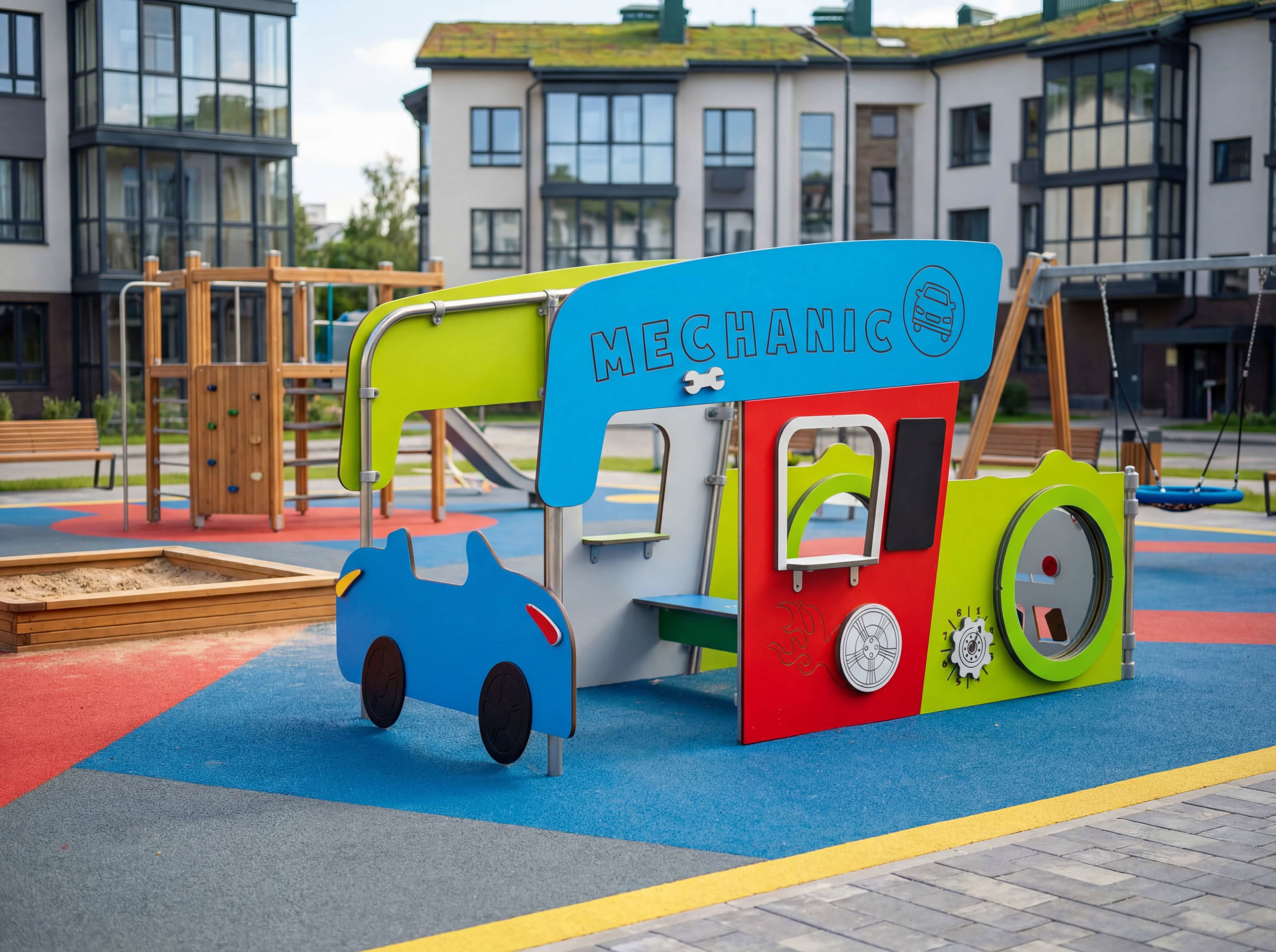 Bunte Autowerkstatt-Spielstation auf einem modernen Spielplatz vor Wohnhäusern.
