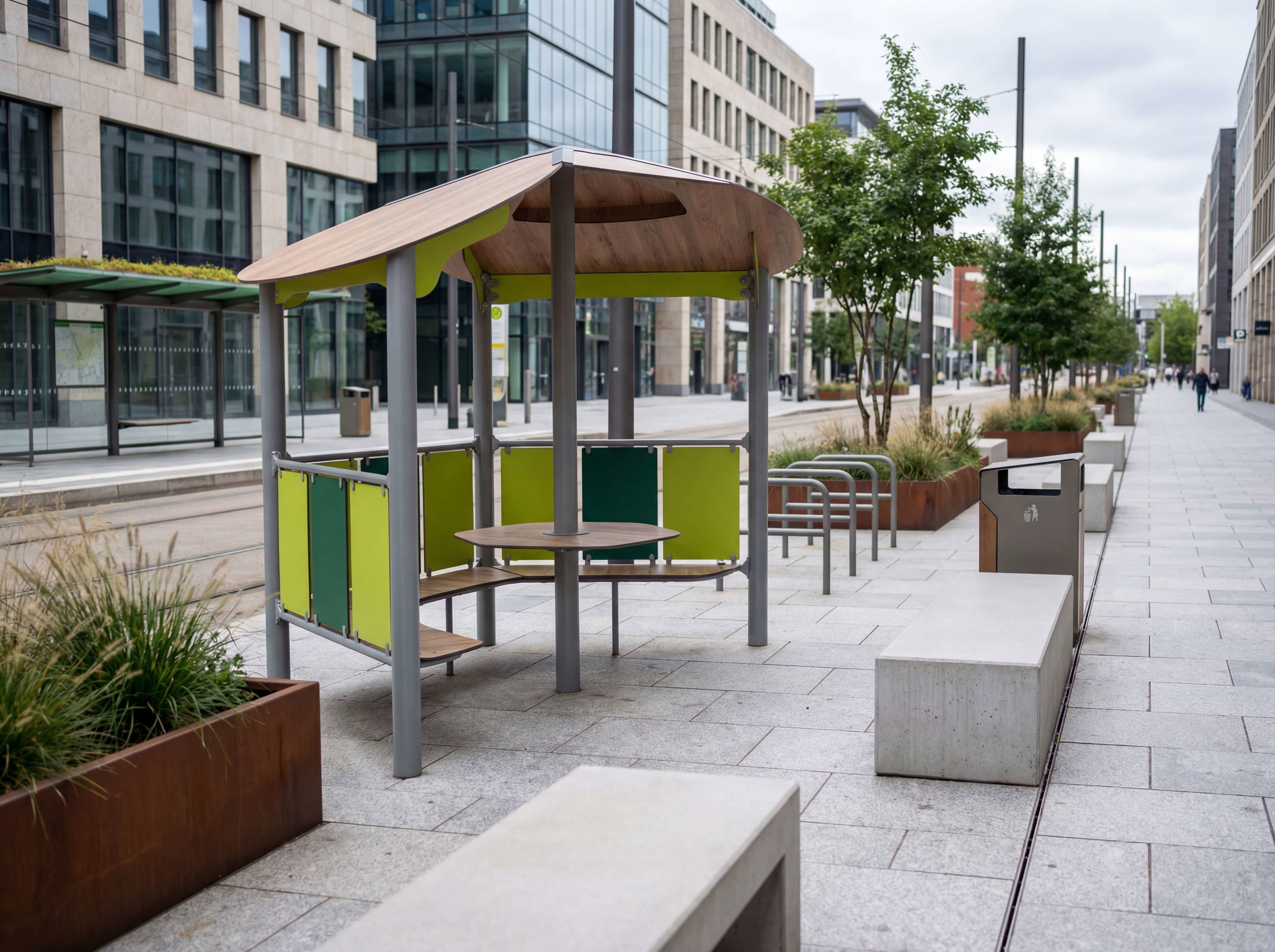 Modern urban seating area with green canopy and benches along paved walkway between buildings.