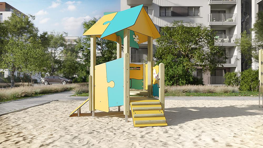 Bunte Puzzle-Spielburg im Sand auf einem städtischen Spielplatz vor Wohnhäusern.
